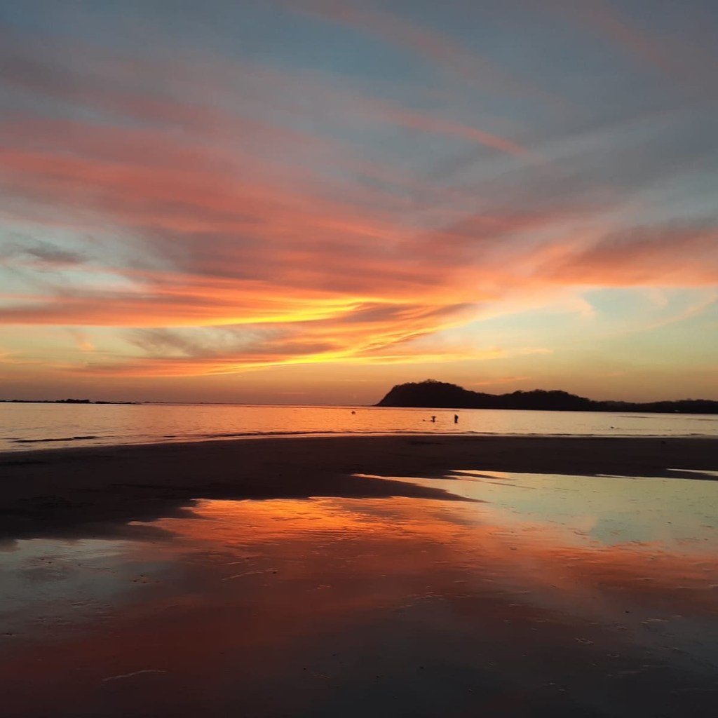 Playa Sámara Costa Rica sunset on beach at low tide with reflections and brilliant colors